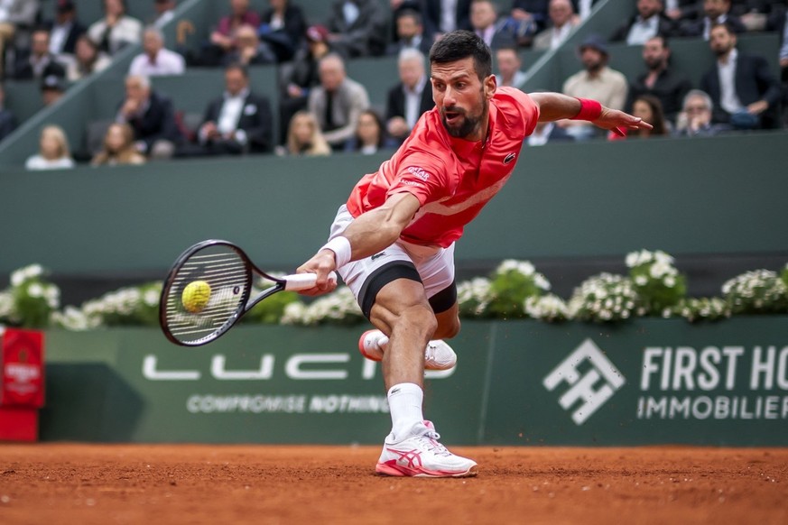 Serbia&#039;s Novak Djokovic returns to Hungary&#039;s Marton Fucsovics during their match at the ATP 250 Geneva Open tennis tournament in Geneva on May 21, 2025. (Photo by FABRICE COFFRINI / AFP)