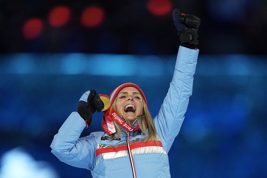 Women&#039;s 30km mass start free cross-country skiing gold medalist Therese Johaug, of Norway, reacts on the podium during the medal ceremony at the closing ceremony of the 2022 Winter Olympics, Sund ...