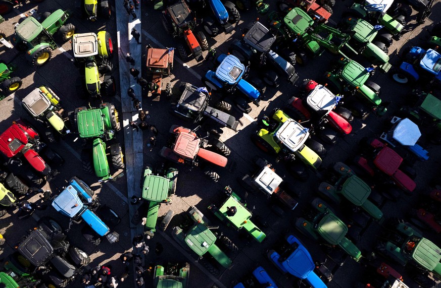 epa11117812 A picture taken with a drone shows farmers in their tractors and agricultural vehicles gathering at the centre of Thessaloniki, Greece, 01 February 2024. Protesting farmers from various pa ...