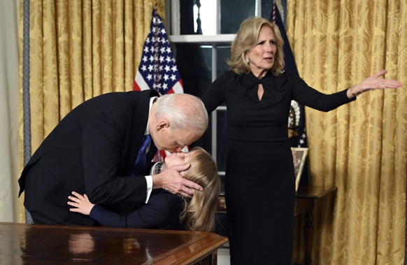 President Joe Biden kisses his grandson Beau Biden as first lady Jill Biden gestures after giving his farewell address from the Oval Office of the White House Wednesday, Jan. 15, 2025, in Washington.  ...