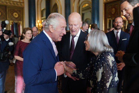 LONDON, ENGLAND - MAY 05: King Charles III (L) speaks to guests during a reception at Buckingham Palace for overseas guests attending the coronation of King Charles III on May 5, 2023 in London, Engla ...
