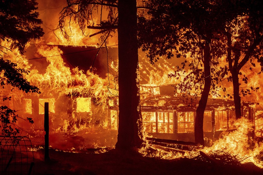 Flames from the Dixie Fire consume a home in the Indian Falls community of Plumas County, Calif., Saturday, July 24, 2021. The fire destroyed multiple residences as it tore through the area. (AP Photo ...