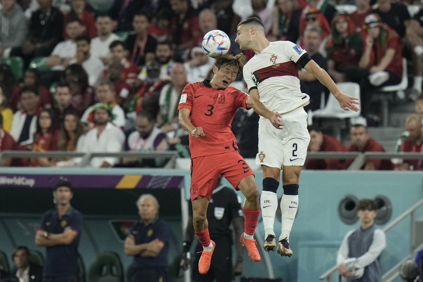 South Korea&#039;s Kim Jin-su, and Portugal&#039;s Diogo Dalot go for a header during the World Cup group H soccer match between South Korea and Portugal, at the Education City Stadium in Al Rayyan ,  ...