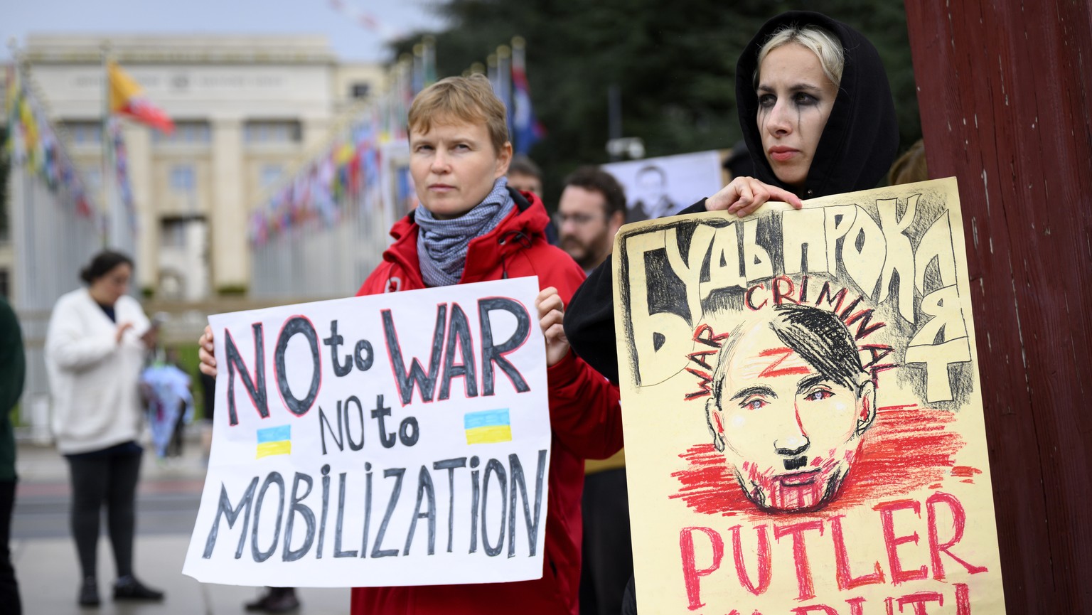 epa10205632 A Russian protestor carries a placard showing a picture of Russian president Vladimir Putin with the name &quot;Putler Kaput !&quot; during a demonstration against the Russian invasion of  ...