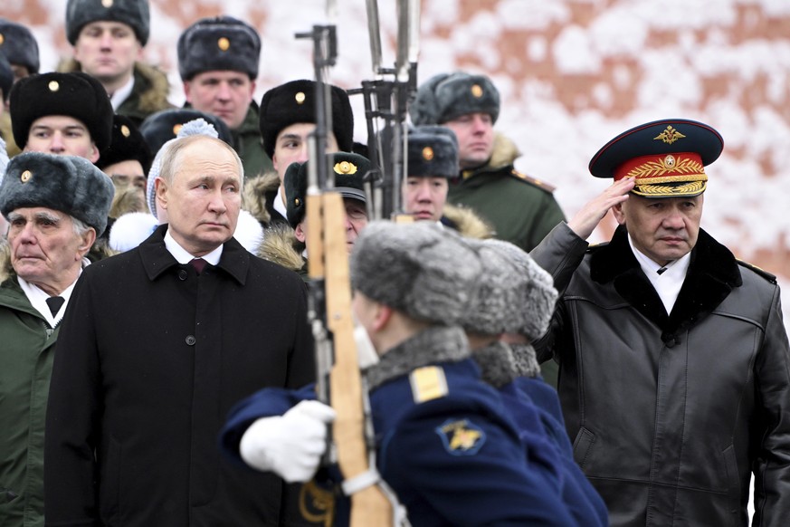 Russian President Vladimir Putin and Defence Minister Sergei Shoigu, right, take part in a wreath laying ceremony at the Tomb of the Unknown Soldier in Alexander Garden on Defender of the Fatherland D ...