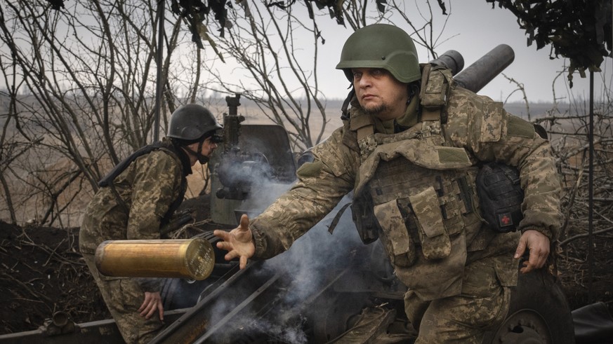 FILE - Ukrainian soldiers with the 71st Jaeger Brigade fire a M101 howitzer at Russian positions on the front line, near the city of Avdiivka in Ukraine&#039;s Donetsk region, on March 22, 2024. Appro ...