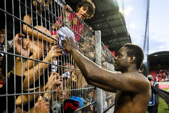 Sion&#039;s forward Mario Balotelli of Italy gives his jersey to fans during the Super League soccer match of Swiss Championship between FC Sion and FC Basel, at the stade de Tourbillon stadium, in Si ...