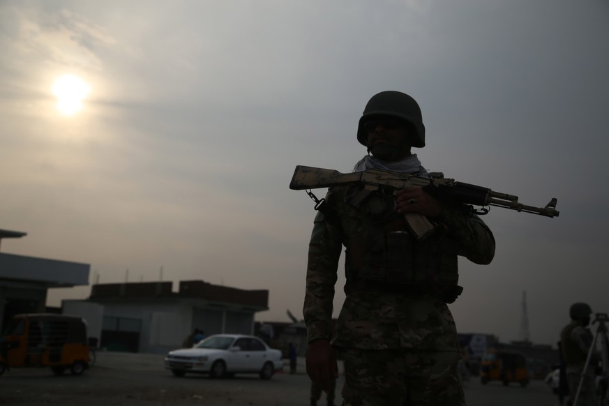 epa09041871 Afghan security officials check people at a check point on the outskirts of Jalalabad, Afghanistan, ahead of the first anniversary of the agreement between the United States and the Taliba ...