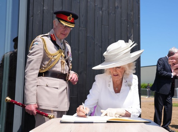 VER-SUR-MER, FRANCE - JUNE 6: King Charles III and Queen Camilla sign the guestbook at the official opening of the Winston Churchill Education and Learning Centre, on the site of the British Normandy ...