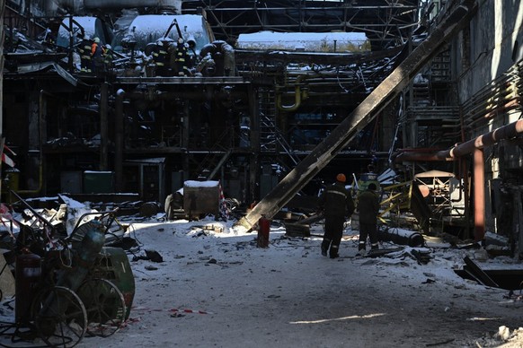 Rescuers of the State Emergency Service and employees of a power plant clear debris at a heavily damaged thermal power plant of the Ukrainian energy provider DTEK in an undisclosed location in Ukraine ...