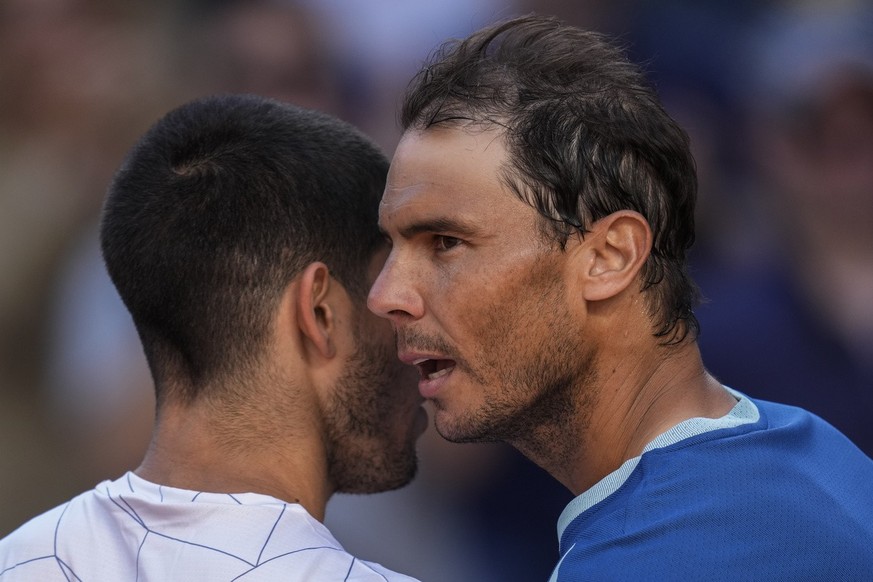 Spain&#039;s Rafael Nadal, right, talks to Spain&#039;s Carlos Alcaraz after their match at the Mutua Madrid Open tennis tournament in Madrid, Friday, May 6, 2022. (AP Photo/Bernat Armangue)