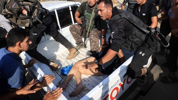 EDITORS NOTE: Graphic content / Palestinian militants surround a truck reportedly carrying a captured Israeli woman, in Khan Yunis in the souther Gaza Strip, on October 7, 2023. Palestinian militants  ...