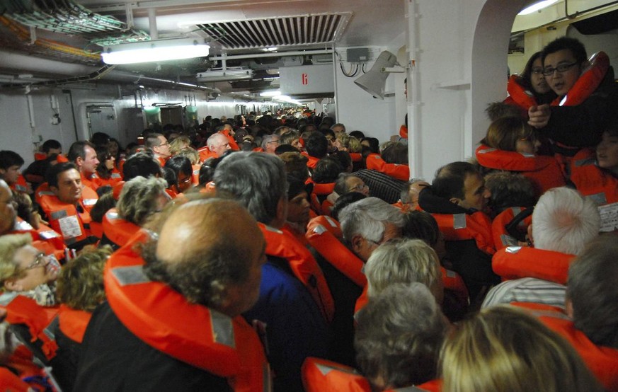 epa03060584 A photo taken by Spanish passenger Carlos Carballa on board cruise boat Costa Concordia and released on 15 January 2012 shows passengers waiting to be evacuated after the ship run aground ...