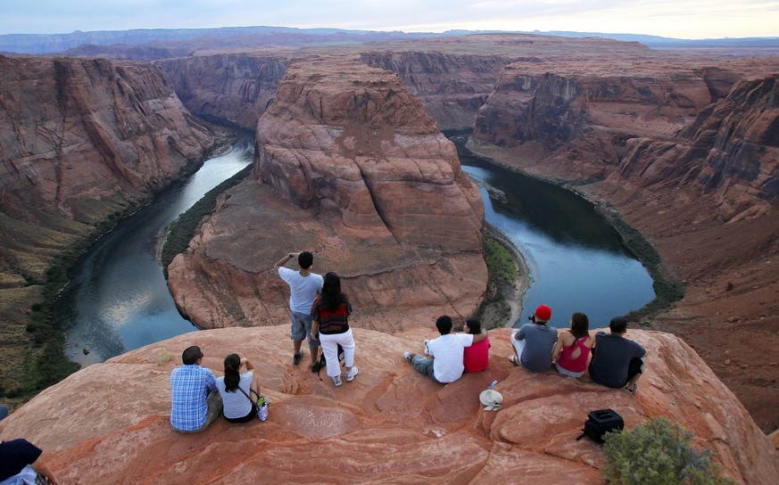 FILE - Visitors view the dramatic bend in the Colorado River at the popular Horseshoe Bend in Glen Canyon National Recreation Area, in Page, Ariz., on Sept. 9, 2011. Federal officials on Tuesday, Aug. ...