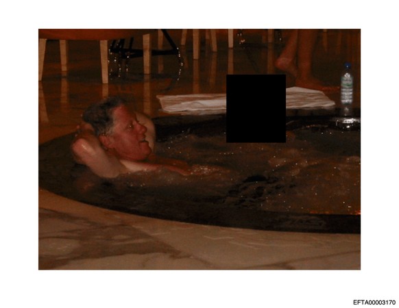 This undated, redacted photo released by the U.S. Department of Justice shows former President Bill Clinton in a hot tub with an unknown person. (U.S. Department of Justice via AP)
Justice Department  ...