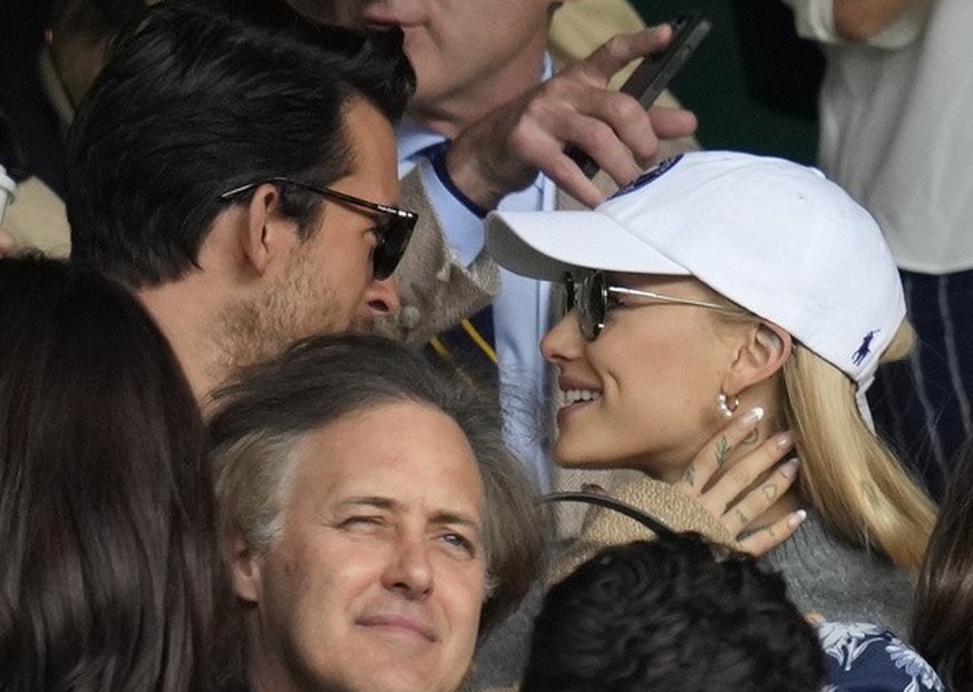 Actor Andrew Garfield, top right, singer Ariana Grande, center, and actor Tom Hiddleston, bottom right, sit in the stands on Centre Court for the final of the men&#039;s singles between Spain&#039;s C ...