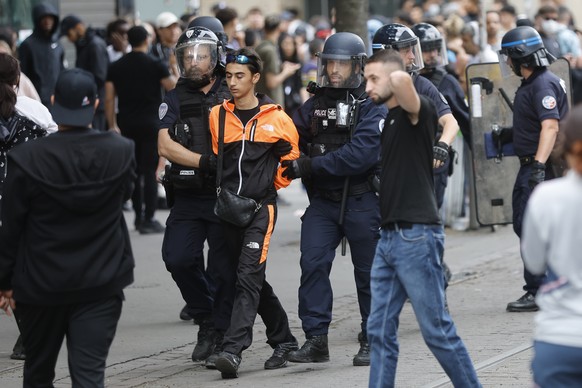 A protester is detained during a protest Friday, June 30, 2023 in Strasbourg, eastern France. French President Emmanuel Macron urged parents Friday to keep teenagers at home and proposed restrictions  ...