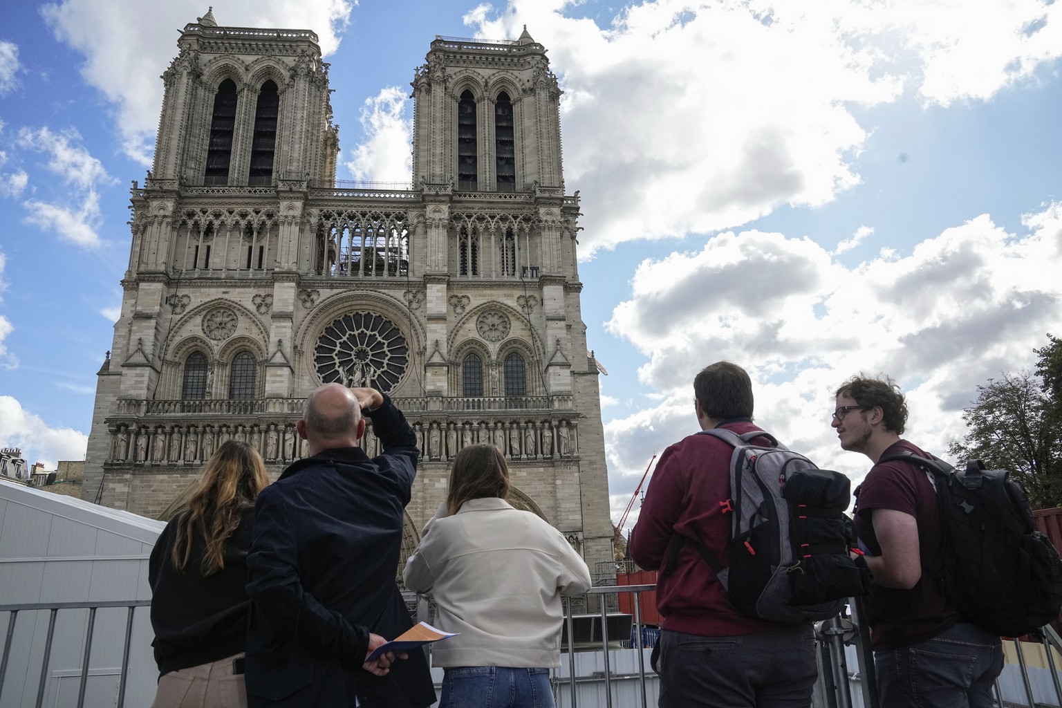 People have a close look of Notre Dame cathedral as they visit the rebuilding site during Heritage Day in Paris, Saturday, Sept. 17, 2022. (AP Photo/Michel Euler)