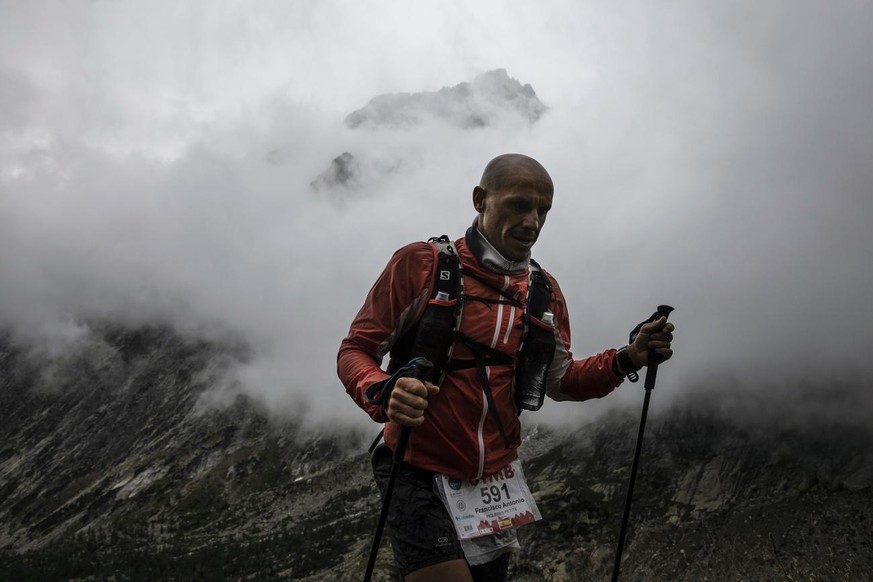 A competitor runs at the Grand Col Ferret as he competes in the 170km Ultra-Trail of Mont-Blanc (UTMB) race, near Courmayeur, Italy, Saturday, Sept 1, 2018. Set up in a breathtaking setting in the hea ...
