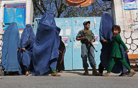 Afghan women leave a polling station after casting their votes in Jalalabad, east of Kabul, Afghanistan, Saturday, June 14, 2014. Despite Taliban threats of violence, many Afghans vow to cast ballots  ...