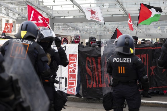 Protestors hold "Smash WEF" banners while members of the police watch the demonstration against the World Economic Forum WEF in Bern, Switzerland, Saturday, January 17, 2026. (KEYSTONE/Peter ...
