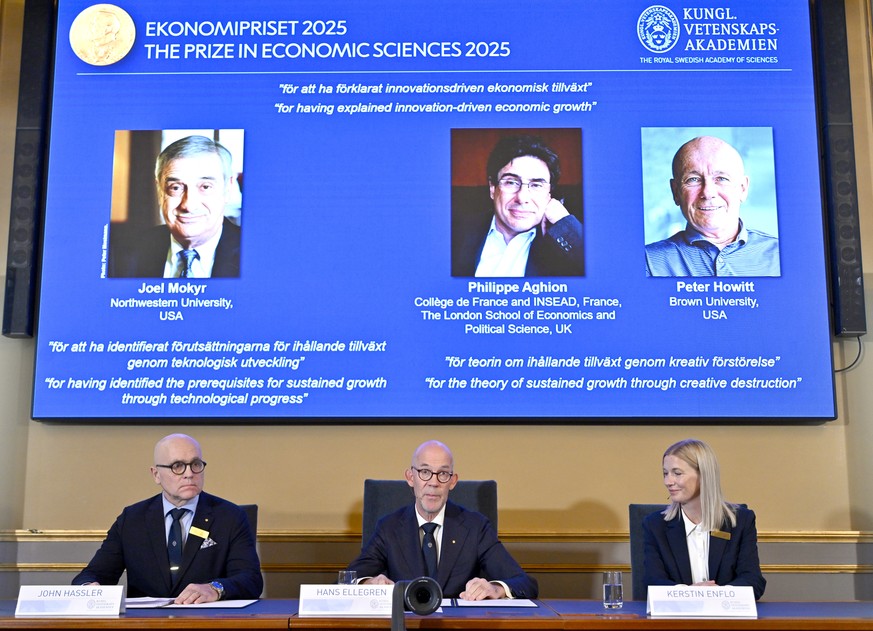 epa12450203 (from L) Professor John Hassler, Chairman of the Committee for the Prize in Economic Sciences in Memory of Alfred Nobel, Hans Ellegren, Permanent Secretary of the Academy of Sciences and P ...