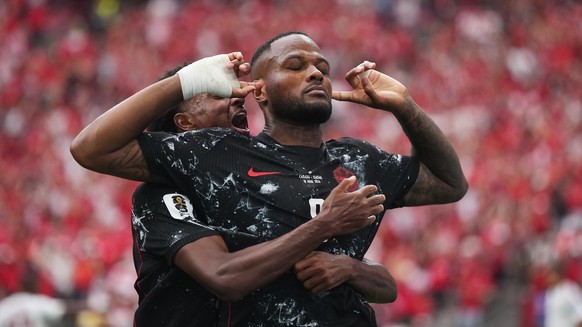 Canada's Cyle Larin (9) celebrates after scoring his sides opening goal during World Cup Group B soccer match between Canada and Qatar in Vancouver, British Columbia, Thursday, June 18, 2026. (Da ...