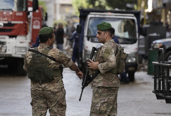 Lebanese soldiers stand guard near the site of Friday&#039;s Israeli strike in Beirut&#039;s southern suburb, Sunday, Sept. 22, 2024. (AP Photo/Bilal Hussein)