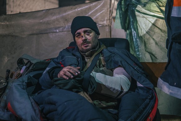 In this photo provided by Azov Special Forces Regiment of the Ukrainian National Guard Press Office, a Ukrainian soldier injured during fighting against Russian forces, poses for a photographer inside ...