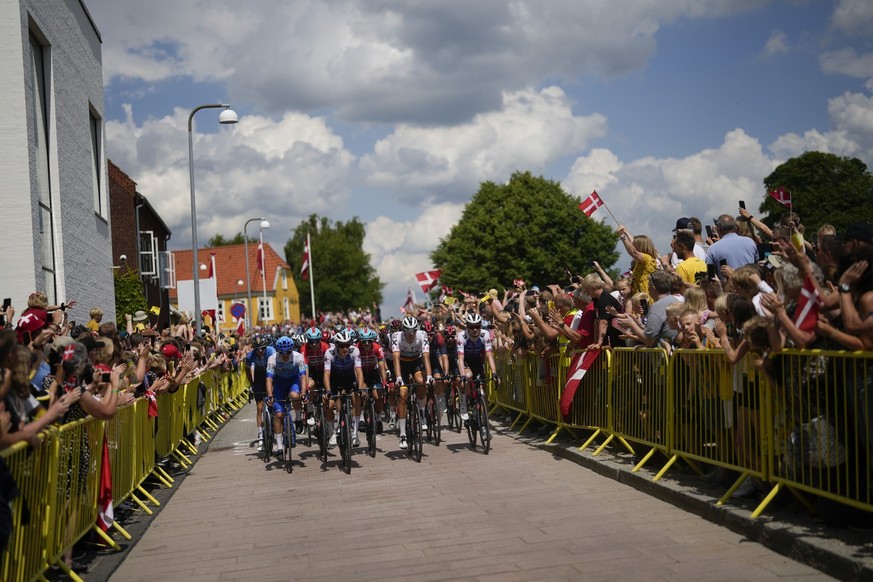 Spectators cheer as the pack passes during the third stage of the Tour de France cycling race over 182 kilometers (113 miles) with start in Vejle and finish in Sonderborg, Denmark, Sunday, July 3, 202 ...