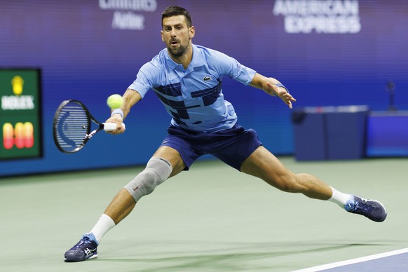 epa11574662 Novak Djokovic of Serbia in action against Alexei Popyrin of Australia, during their third round match of the US Open Tennis Championships at the USTA Billie Jean King National Tennis Cent ...