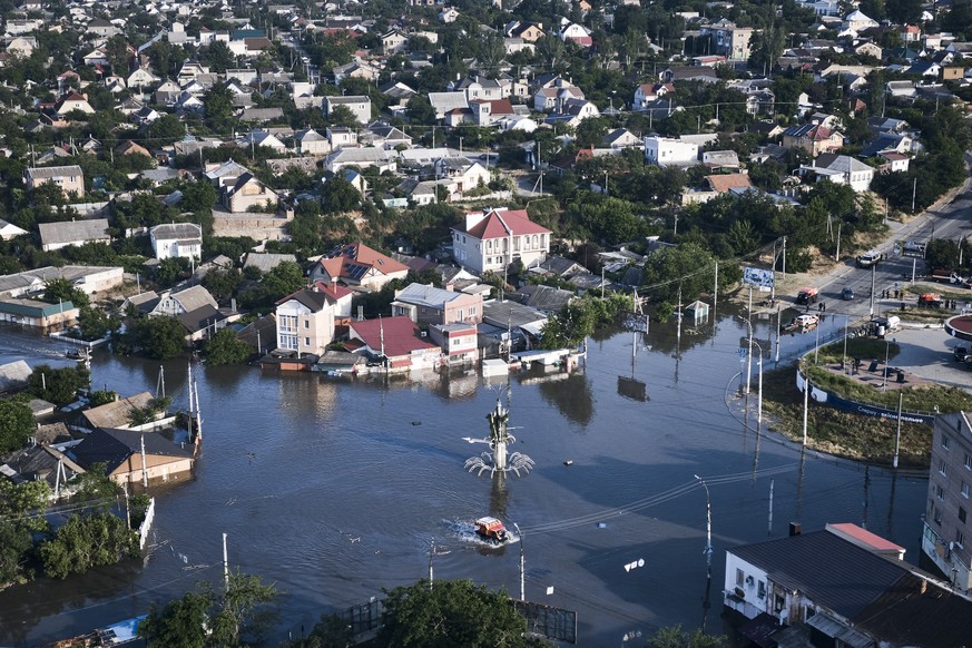 Streets are flooded in Kherson, Ukraine, Wednesday, June 7, 2023 after the Kakhovka dam was blown up. Residents of southern Ukraine, some who spent the night on rooftops, braced for a second day of sw ...