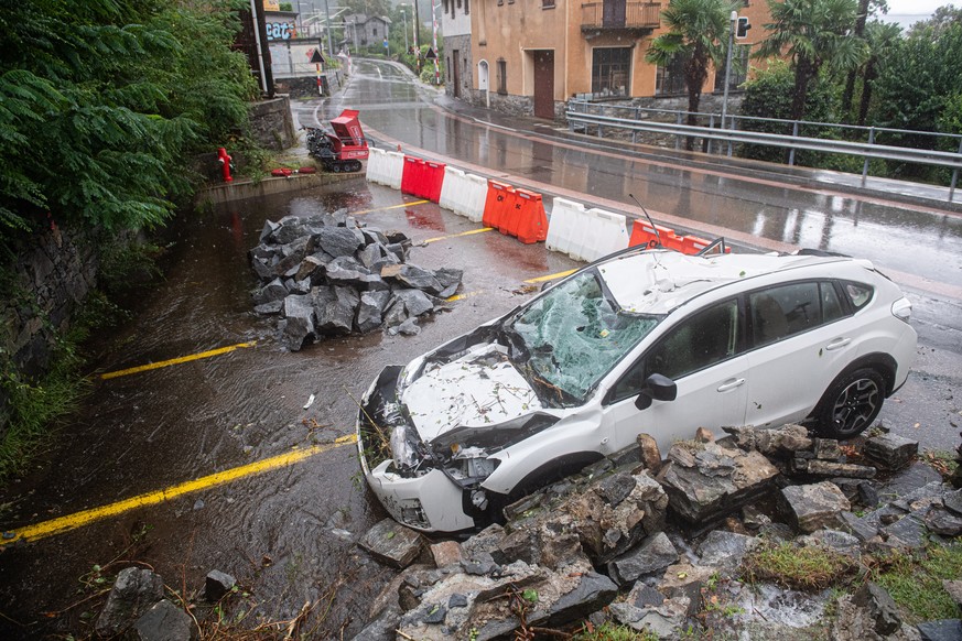 epa10823486 A car was destroyed by a rockfall caused by heavy rainfall in southern Switzerland in Biasca, Switzerland, 27 August 2023. The canton Tessin, the Italian part of Switzerland, got a lot of  ...