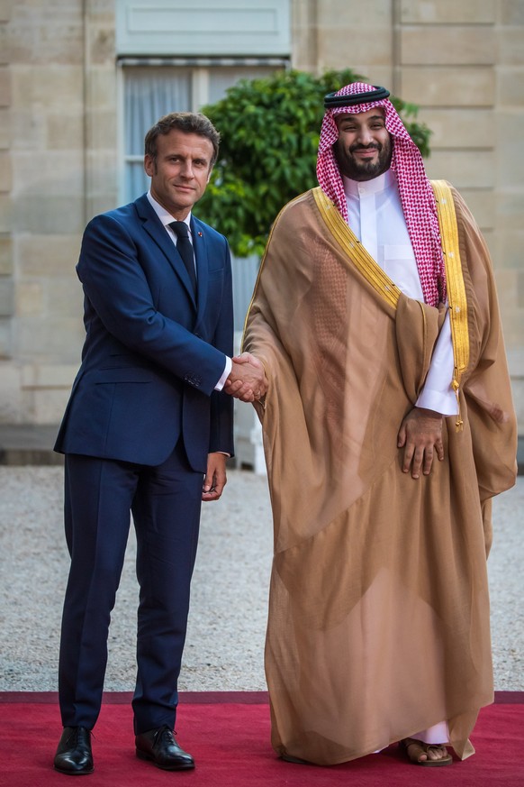 epa10096331 French President Emmanuel Macron (L) shakes hand with Crown Prince, Mohammed Bin Salman Bin Abdulaziz Al-Saud (R), Vice President of the Council of Ministers of Defence of the Kingdom of S ...