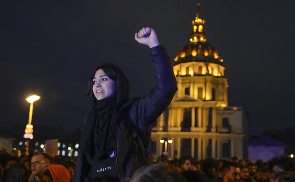 A protester chants slogans during a protest in Paris, Monday, March 20, 2023. The French government has survived two no-confidence votes in the lower chamber of parliament, proposed by lawmakers who o ...