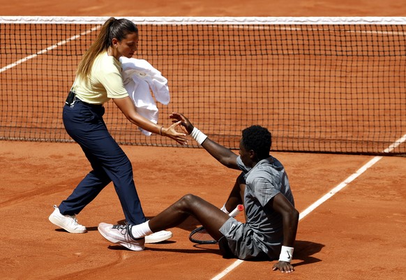 epaselect epa13000243 Moise Kouame of France is helped to get up during his Men's 2nd round match against Adolfo Daniel Vallejo of Paraguay at the French Open Grand Slam tennis tournament at Rola ...