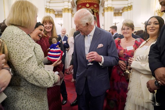 Britain&#039;s King Charles III speaks to guests during a reception in Buckingham Palace, London, in celebration of community-based initiatives raising awareness about cancer and supporting those livi ...