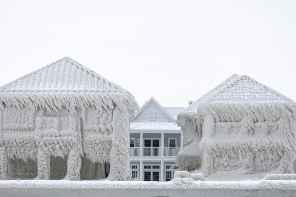 Houses along the shores of Lake Erie, near Fort Erie, Ontario,, remain covered in ice Tuesday, Dec. 27, 2022, following a winter storm that swept through much of Ontario. (Nick Iwanyshyn/The Canadian  ...