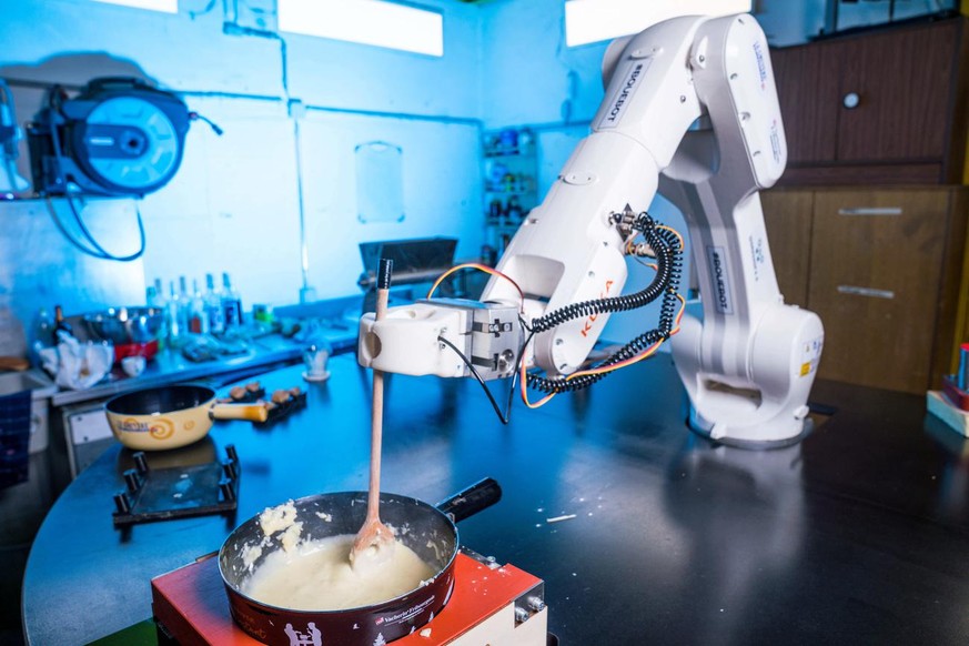 The world&#039;s first robot &quot;Bouebot&quot; is preparing a cheese fondue at the start-up workshop4.0 headquarter, in Sierre, Switzeland, on Monday, February 21, 2022. A robot, named Bouebot, has  ...