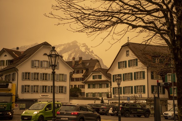 The downtown of Stanssappears in new colours, as Sahara sand colours the sky in orange and creates a special light atmosphere, Switzerland, Tuesday, March 15, 2022. (KEYSTONE/Urs Flueeler)