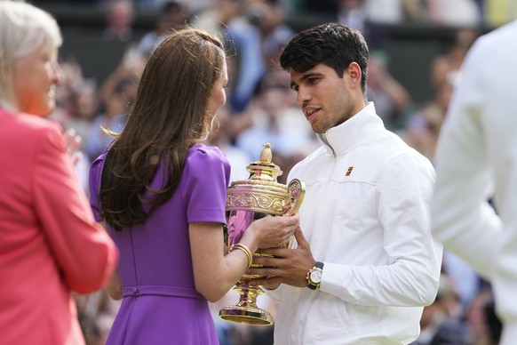 Carlos Alcaraz of Spain receives his trophy from Kate, Princess of Wales after defeating Novak Djokovic of Serbia in the men&#039;s singles final at the Wimbledon tennis championships in London, Sunda ...