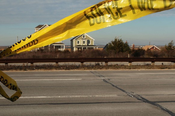 BABYLON, NY - DECEMBER 17: Suffolk County police crime tape is viewed in an area where police are still searching after finding four discarded bodies along a quarter-mile stretch of beachside road in  ...