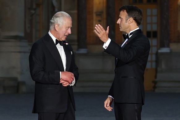 French President Emmanuel Macron, right, his wife Brigitte Macron, left, Britain's King Charles III, second from right, and Queen Camilla arrive for a state dinner, at the Chateau de Versailles, ...