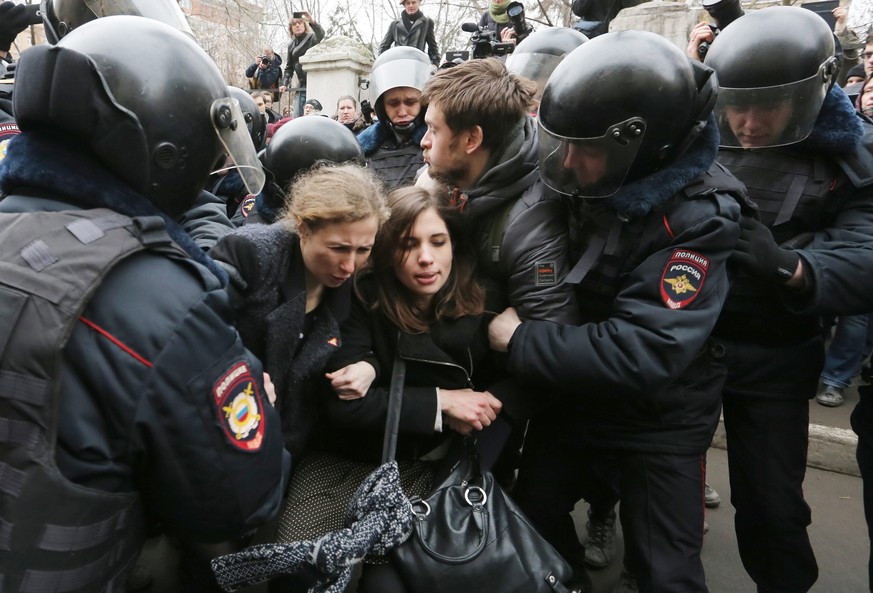 epa04098646 Riot police detain Pussy Riot feminist punk group members Maria Aliokhina (L), Nadezhda Tolokonnikova (C) and her husband Piotr Verzilov (R) during a protest action in front of Zamosvorets ...