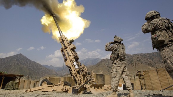 FILE - A 155mm round is fired from a 777 Howitzer canon at insurgents during a firing mission by soldiers with 2nd Platoon, Charlie Battery, 3rd Battalion, 321 Field Artillery Regiment out of Fort Bra ...