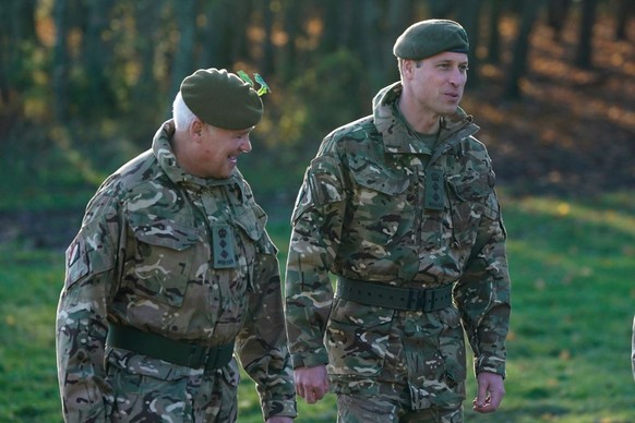 SALISBURY, ENGLAND - NOVEMBER 23: Prince William, Prince of Wales, Colonel-in-Chief, 1st Battalion Mercian Regiment (L) listens to a briefing ahead of an attack exercise during a visit to the regiment ...