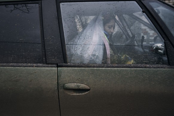 Ukrainian army medic Eugenia enters a car after her wedding ceremony in Lyman, Donetsk region, Ukraine, Saturday, Dec. 24, 2022. (AP Photo/Felipe Dana)