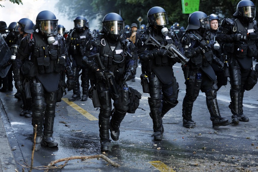 KEYPIX - No-G7 activists clash with riot police amid tear gas smoke in a demonstration against the G7 summit scheduled to take place June 15-17 in Evian, held in Geneva, Switzerland, Sunday, June 14, ...