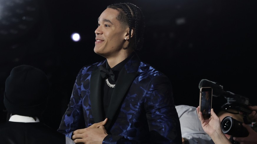 Yanic Konan Niederhauser, reacts after being selected 30th by the Los Angeles Clippers in the first round of the NBA basketball draft, Wednesday, June 25, 2025, in New York. (AP Photo/Adam Hunger)