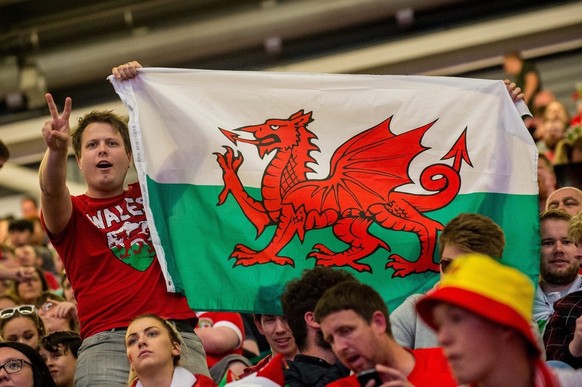 epa05411416 Welsh fans in the fan zone set up in the Principality Stadium, Cardiff, Wales, Britain, 06 July 2016, watching the UEFA EURO 2016 semi final between Portugal and Wales. EPA/ALED LLYWELYN